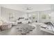 Spacious living room featuring stylish white furniture, large windows, and decorative plush rugs at 5120 Bridge St # 6, Tampa, FL 33611