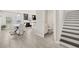 Open-concept living space that leads to a dining area, kitchen, powder room and stairs at 5120 Bridge St # 6, Tampa, FL 33611