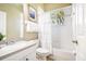 Cozy bathroom featuring a vanity, toilet, and shower-tub combination with decorative curtain at 5384 Mira Vista Dr, Palm Harbor, FL 34685