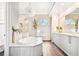 Elegant bathroom with a soaking tub, granite counters, modern cabinets, and a large window at 5384 Mira Vista Dr, Palm Harbor, FL 34685