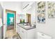 Bright bathroom features dual sinks, modern fixtures, and a large mirror, offering a stylish and functional space at 5384 Mira Vista Dr, Palm Harbor, FL 34685