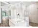 Bright bathroom featuring a soaking tub, a walk-in shower, and stylish accents at 5384 Mira Vista Dr, Palm Harbor, FL 34685