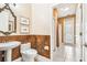 A half bath featuring an ornate mirror, pedestal sink, and decorative wall accents at 5384 Mira Vista Dr, Palm Harbor, FL 34685