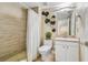 Modern bathroom with neutral tile, a walk-in shower and contemporary fixtures at 5384 Mira Vista Dr, Palm Harbor, FL 34685