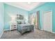 Bedroom with cool blue walls and carpet and a large window at 5384 Mira Vista Dr, Palm Harbor, FL 34685