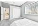 Bright bedroom featuring a large window, closet space, and neutral tones, creating a serene and comfortable retreat at 5384 Mira Vista Dr, Palm Harbor, FL 34685