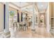 Elegant dining room features tray ceilings, tile floors, chandelier, and floor to ceiling mirror at 5384 Mira Vista Dr, Palm Harbor, FL 34685