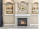 Elegant fireplace with tile surround and mantle, flanked by decorative art niches at 5384 Mira Vista Dr, Palm Harbor, FL 34685