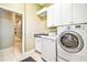 Functional laundry room equipped with modern washer and dryer, sink, and cabinets for organized storage solutions at 5384 Mira Vista Dr, Palm Harbor, FL 34685