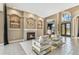 Spacious living room with a fireplace, tile floors, high ceilings, and French doors at 5384 Mira Vista Dr, Palm Harbor, FL 34685
