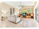 Bright living room with tiled floor, large sofa, custom media center and vaulted ceiling with fan at 5384 Mira Vista Dr, Palm Harbor, FL 34685