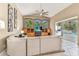 Open living room featuring a vaulted ceiling, built-in entertainment center, and access to the lanai at 5384 Mira Vista Dr, Palm Harbor, FL 34685