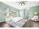 Spacious main bedroom featuring light green walls, wood floors, tray ceilings, and French doors at 5384 Mira Vista Dr, Palm Harbor, FL 34685