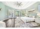 Tranquil main bedroom suite featuring wood floors, and French doors offering plenty of natural light at 5384 Mira Vista Dr, Palm Harbor, FL 34685