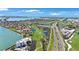 Scenic aerial view of beachfront condo complex with lush golf course and convenient highway access at 5700 Escondida S Blvd # 506, St Petersburg, FL 33715