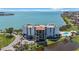 Waterfront condo with community pool, pond, bay views, and palm tree landscaping at 5700 Escondida S Blvd # 506, St Petersburg, FL 33715