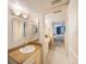 Bathroom with a single sink with granite countertops and a view to the bedroom at 5700 Escondida S Blvd # 506, St Petersburg, FL 33715