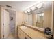 Bathroom with granite countertops, double sink, and a view to the water closet and shower at 5700 Escondida S Blvd # 506, St Petersburg, FL 33715