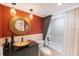 Bathroom showcasing modern vanity with a large round mirror and a separate tub and shower area at 5700 Escondida S Blvd # 506, St Petersburg, FL 33715