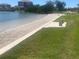 Picturesque beach area with smooth sand, gentle water, and grassy surroundings at 5700 Escondida S Blvd # 506, St Petersburg, FL 33715