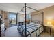 A well lit bedroom leading to a balcony with seating at 5700 Escondida S Blvd # 506, St Petersburg, FL 33715