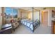 Bright bedroom featuring natural light, a four-poster bed, and comfortable furnishings at 5700 Escondida S Blvd # 506, St Petersburg, FL 33715