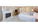 Bright bedroom features a fireplace, dresser, and comfortable king-sized bed at 5700 Escondida S Blvd # 506, St Petersburg, FL 33715