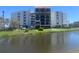 Condo building with private balconies, lake views and lush, mature landscaping at 5700 Escondida S Blvd # 506, St Petersburg, FL 33715