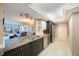 Bright kitchen featuring granite counters, stainless steel appliances, and an open layout into the living area at 5700 Escondida S Blvd # 506, St Petersburg, FL 33715