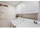 Convenient laundry room featuring white cabinets and a washer and dryer for easy living at 5700 Escondida S Blvd # 506, St Petersburg, FL 33715
