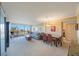 Open living room and dining area filled with natural light, modern furniture, and balcony with a view at 5700 Escondida S Blvd # 506, St Petersburg, FL 33715