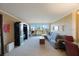 Spacious living room featuring modern furniture, an entertainment center, and bright views to the balcony at 5700 Escondida S Blvd # 506, St Petersburg, FL 33715