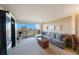 Comfortable living room including a modern entertainment center, neutral carpet, and plenty of natural light at 5700 Escondida S Blvd # 506, St Petersburg, FL 33715