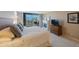 Bright main bedroom with large windows, balcony access, fireplace, and dresser at 5700 Escondida S Blvd # 506, St Petersburg, FL 33715