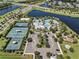 Aerial view of the community clubhouse with pool, tennis courts, playground and lake at 6617 Park Strand Dr, Apollo Beach, FL 33572