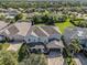 Expansive aerial view of a well-maintained home nestled among lush trees, showcasing its prime location in a serene neighborhood at 6617 Park Strand Dr, Apollo Beach, FL 33572