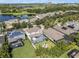 Scenic aerial view of the property with a screened-in pool, lush greenery, and neighborhood at 6617 Park Strand Dr, Apollo Beach, FL 33572