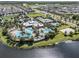 Aerial view of community pool with waterslides, palm trees, and surrounding residential area at 6617 Park Strand Dr, Apollo Beach, FL 33572