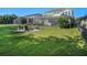 Spacious backyard featuring a screened-in pool, fire pit, and ample grassy area at 6617 Park Strand Dr, Apollo Beach, FL 33572