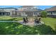 Beautiful backyard featuring a fire pit surrounded by Adirondack chairs, perfect for outdoor gatherings at 6617 Park Strand Dr, Apollo Beach, FL 33572