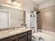 Bathroom with tiled shower, granite vanity, and ample storage space at 6617 Park Strand Dr, Apollo Beach, FL 33572