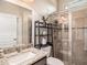 Bathroom featuring granite vanity, glass shower, and modern tile work at 6617 Park Strand Dr, Apollo Beach, FL 33572