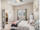 Bedroom with neutral color palette, lots of natural light, and ensuite bathroom at 6617 Park Strand Dr, Apollo Beach, FL 33572