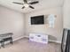 Bonus room with a large tv, electric fireplace, and keyboard at 6617 Park Strand Dr, Apollo Beach, FL 33572