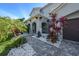 Inviting front entrance with arched columns, manicured landscaping, and a paved walkway at 6617 Park Strand Dr, Apollo Beach, FL 33572