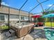 Relaxing hot tub located within a screened-in enclosure, next to the pool and outdoor seating area at 6617 Park Strand Dr, Apollo Beach, FL 33572