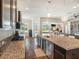Modern kitchen with granite countertops, stainless steel appliances, and an island overlooking the living room at 6617 Park Strand Dr, Apollo Beach, FL 33572