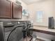 Laundry room with granite counters and stainless steel Samsung washer and dryer at 6617 Park Strand Dr, Apollo Beach, FL 33572