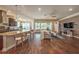 Open-concept living space with a stylish kitchen island, comfortable seating, and hardwood floors, perfect for entertaining at 6617 Park Strand Dr, Apollo Beach, FL 33572