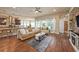 Bright living room with hardwood floors and neutral decor, showcasing an open floor plan at 6617 Park Strand Dr, Apollo Beach, FL 33572